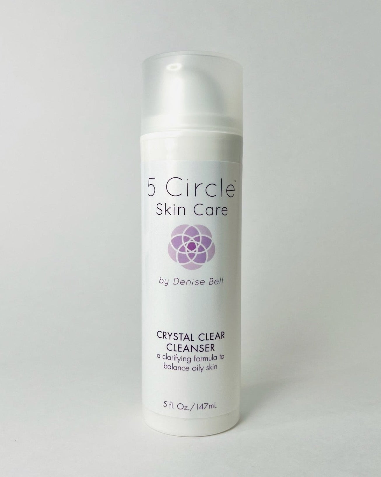 A pump bottle of Crystal Clear Cleanser by 5 Circle Skin Care, with product details and branding visible.